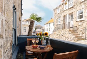 Take wine and nibbles out to the courtyard.