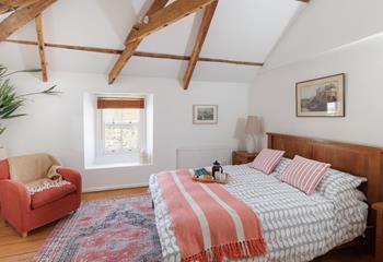 Exposed beams give the main bedroom a characterful and luxurious feel!