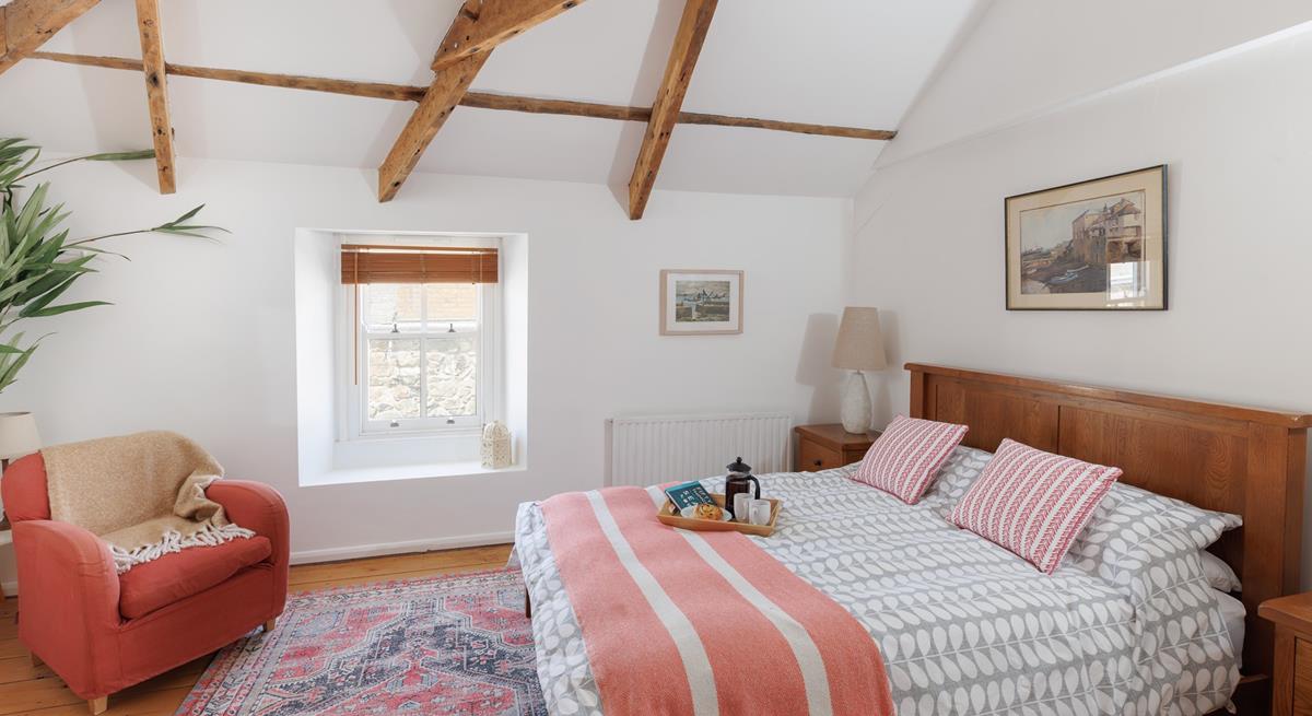 Exposed beams give the main bedroom a characterful and luxurious feel!