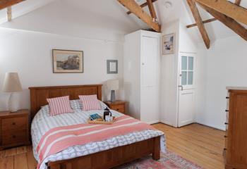 The bedroom is spacious and filled with light.