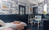 The twin room is decorated with fun nautical wallpaper. - Thumbnail Image