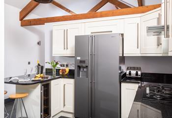 The spacious kitchen is very well-equipped, making it easy to whip up delicious home-cooked meals.