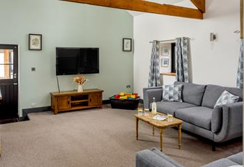 The lounge is spacious and homely with vibrant colours and textures. Perfect for a family games night!