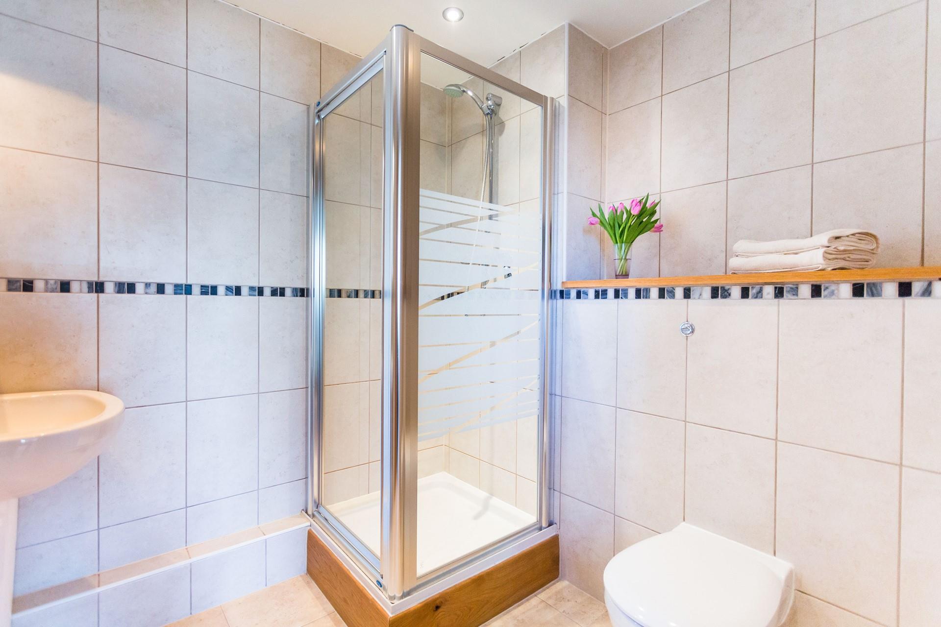 Wash off sandy toes in the shower room after a day on Fistral Beach.