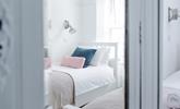 Pastel bedding creates a calming space. - Thumbnail Image