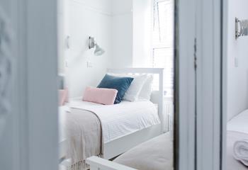 Pastel bedding creates a calming space.