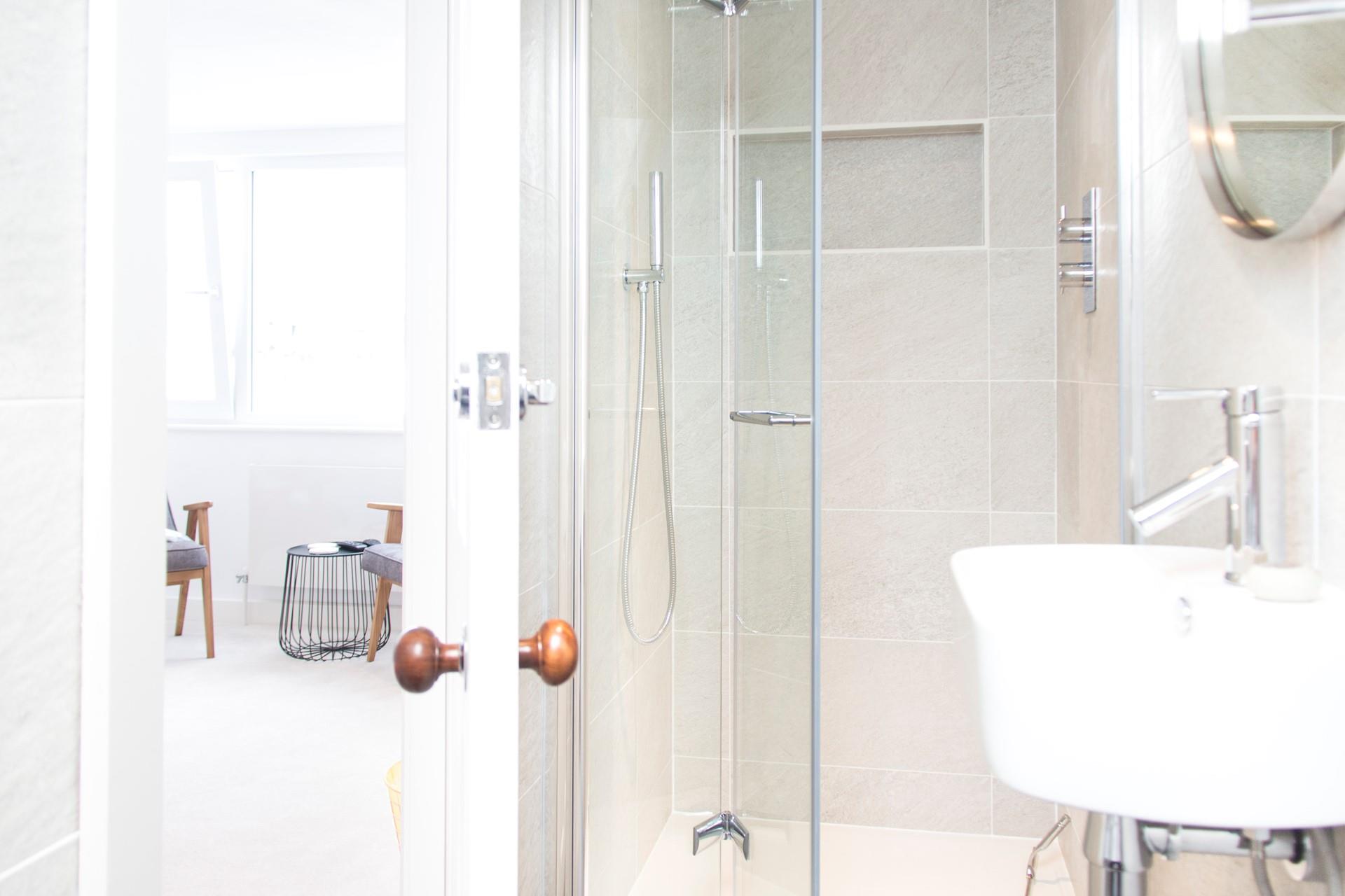 The modern en suite has a shower, WC and basin.