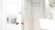 The modern en suite has a shower, WC and basin.