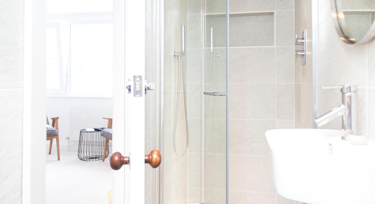 The modern en suite has a shower, WC and basin.