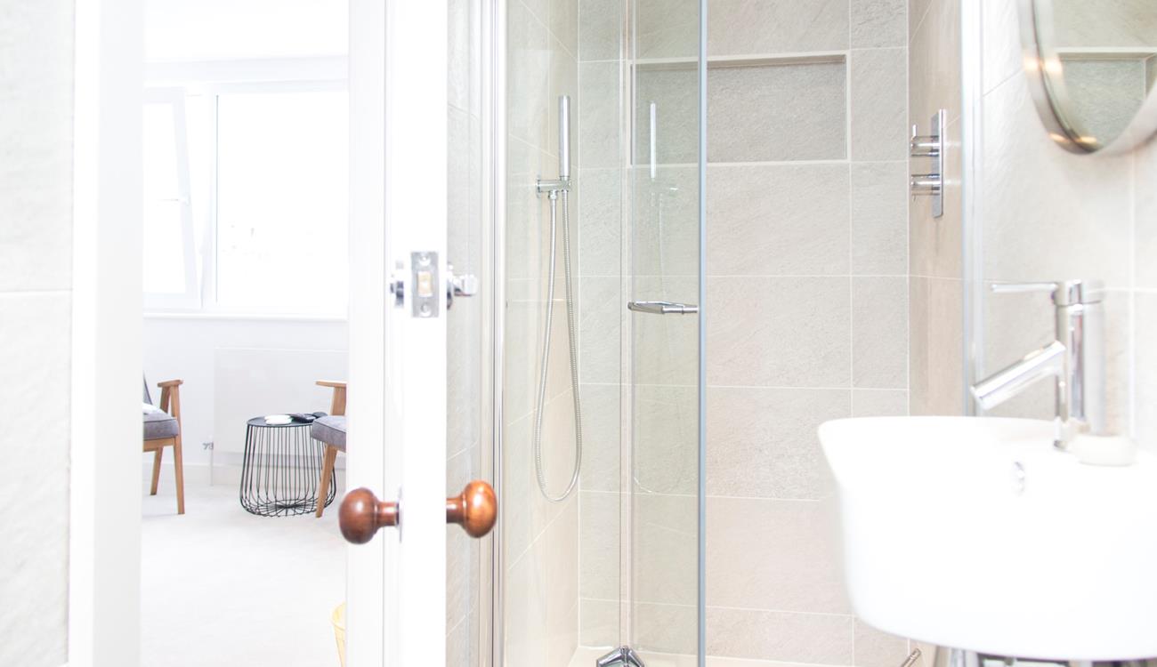 The modern en suite has a shower, WC and basin.