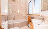 Relax and unwind with a soak in the tub. - Thumbnail Image