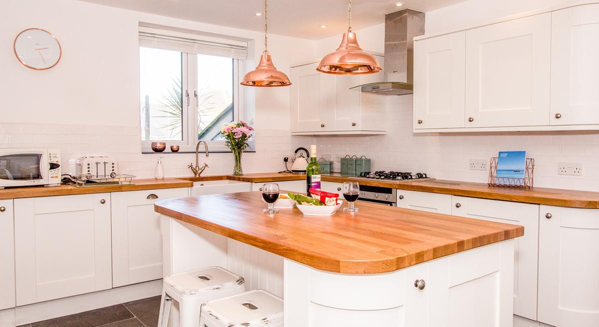 Beautifully appointed kitchen with island and seating for 2.
