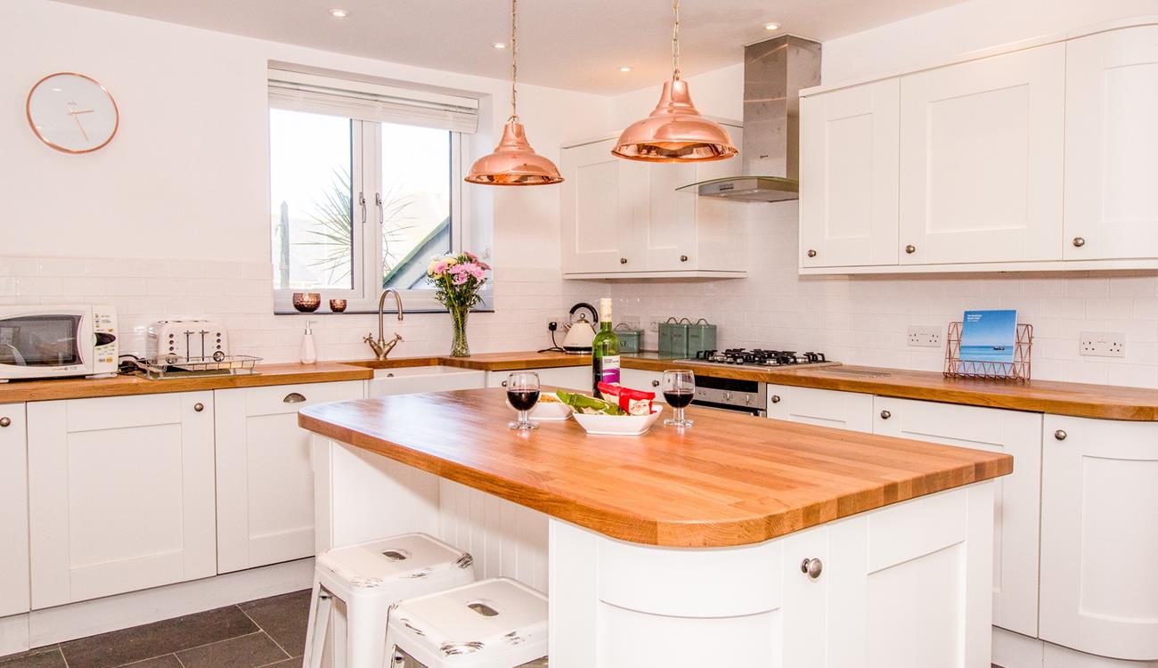 Beautifully appointed kitchen with island and seating for 2.
