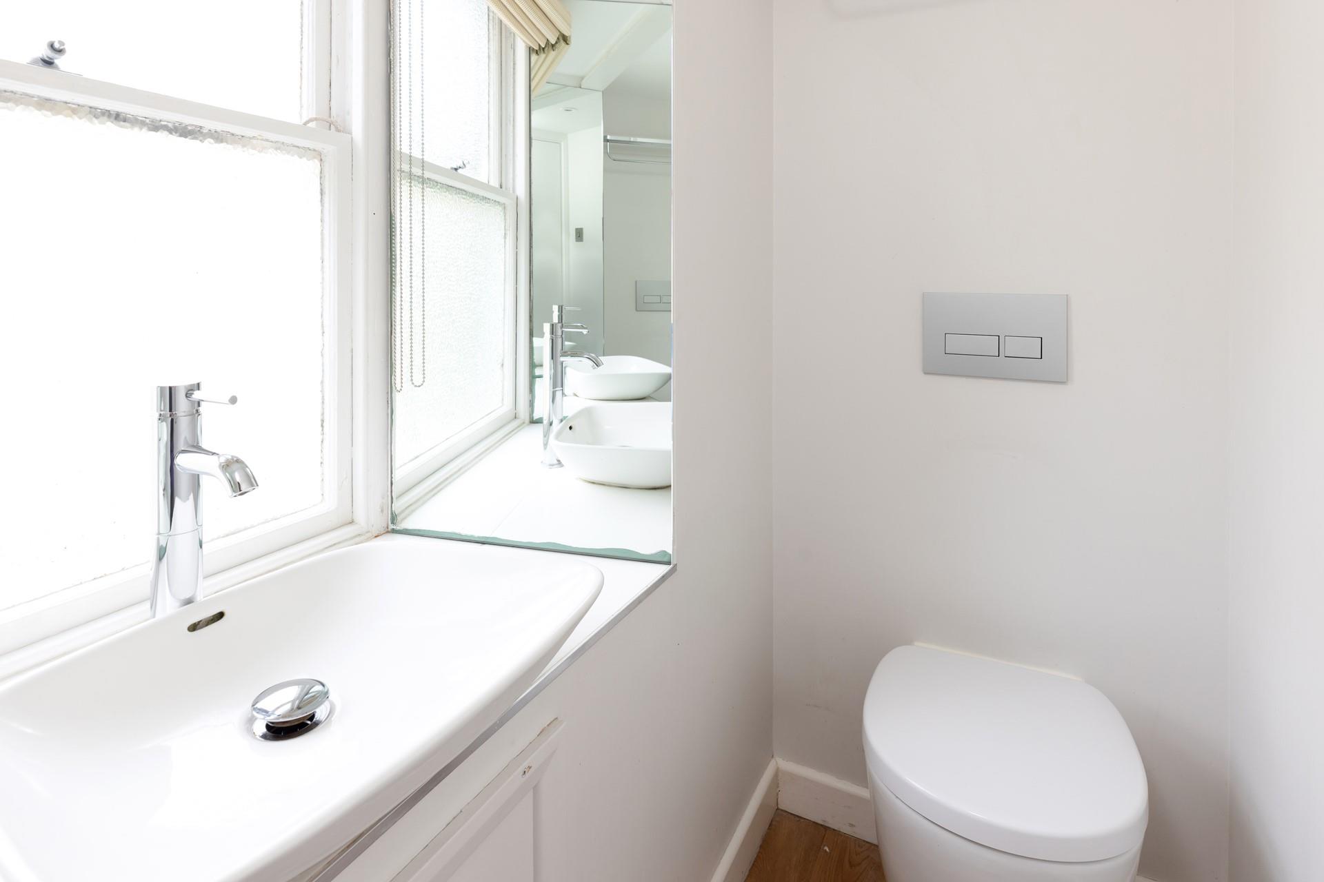 The bright and modern bathroom is the perfect place to get ready for the day. 
