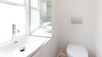 The bright and modern bathroom is the perfect place to get ready for the day. 