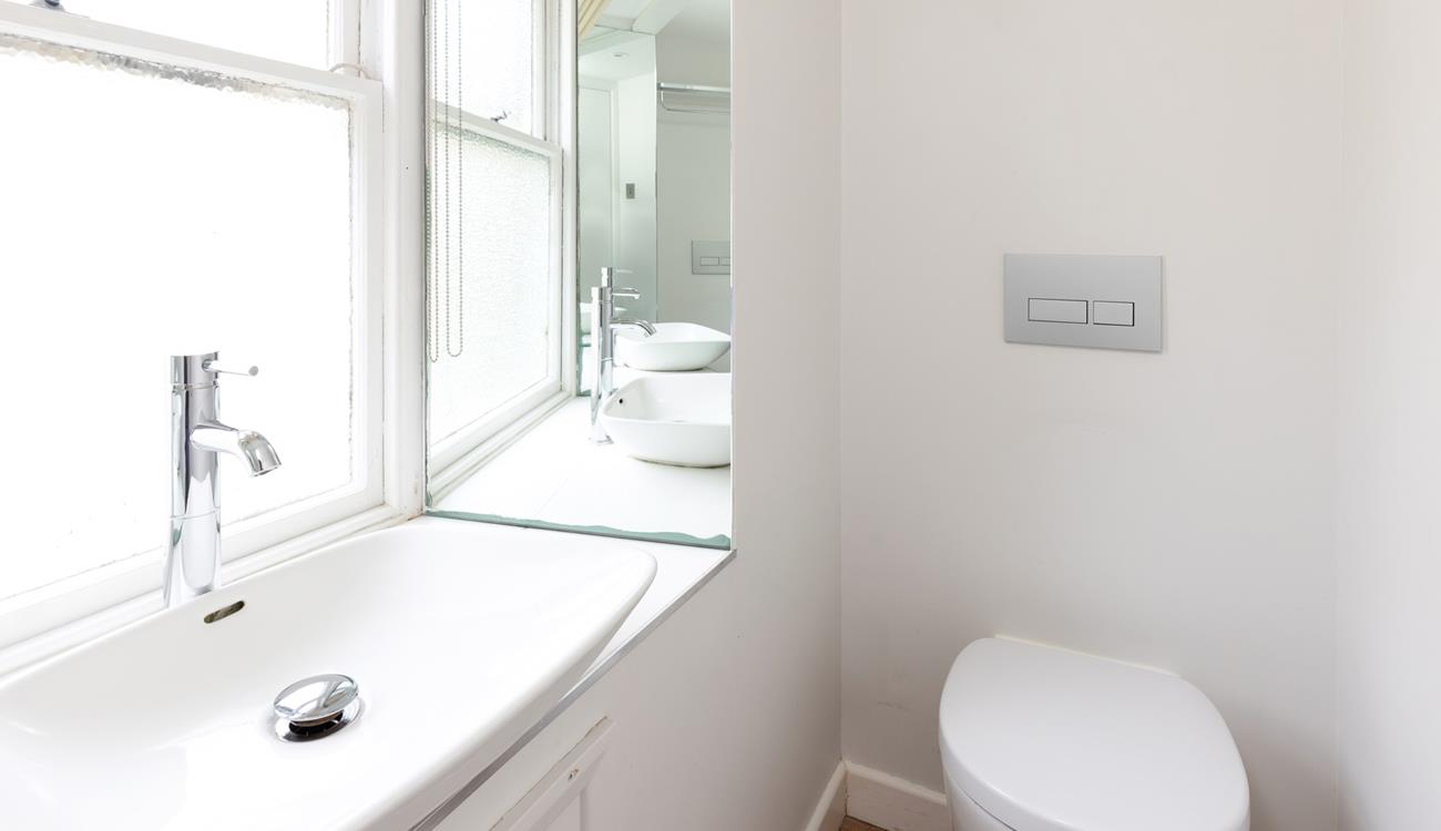 The bright and modern bathroom is the perfect place to get ready for the day. 