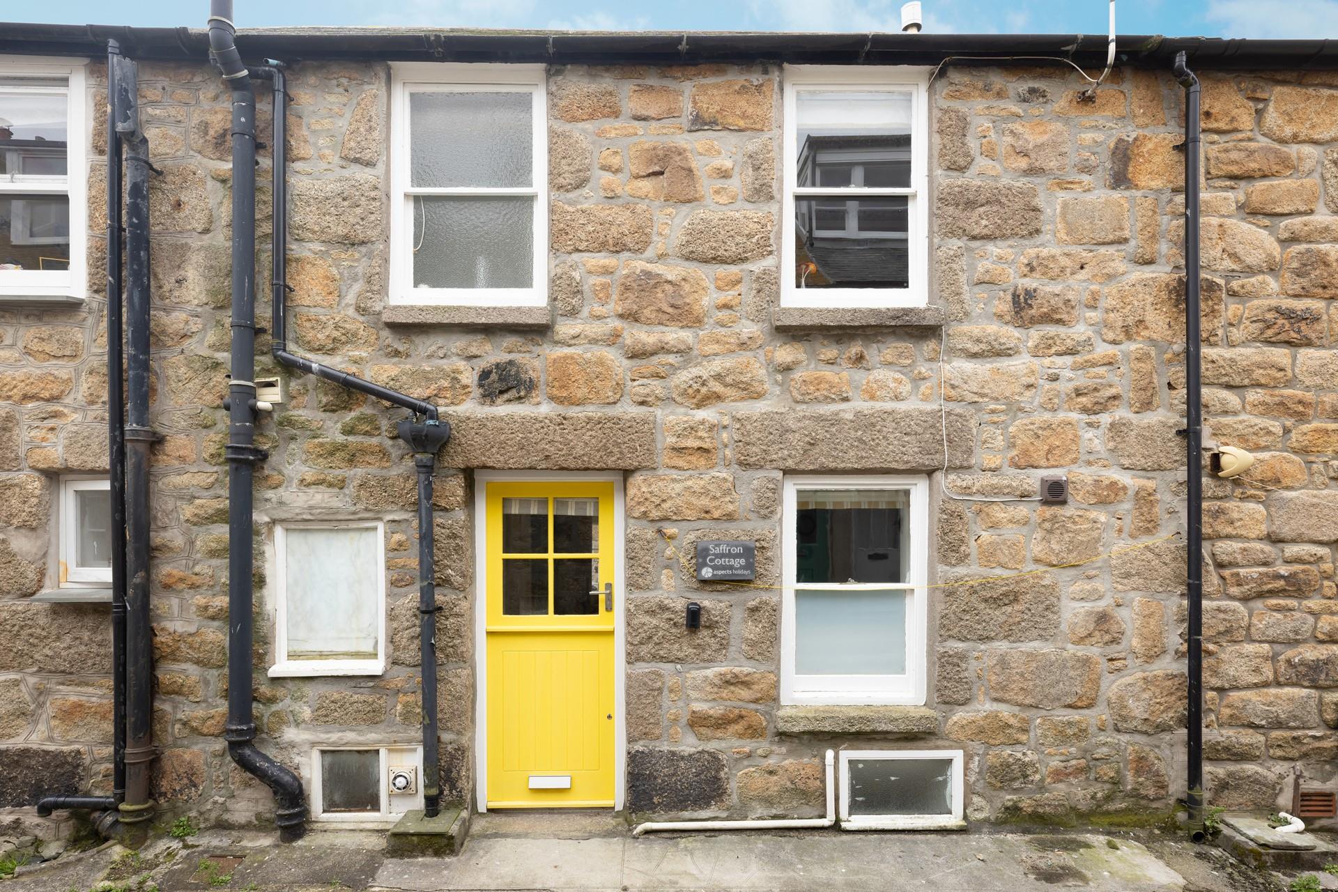 With it's bright yellow front-door, Saffron Cottage is easy to spot. 