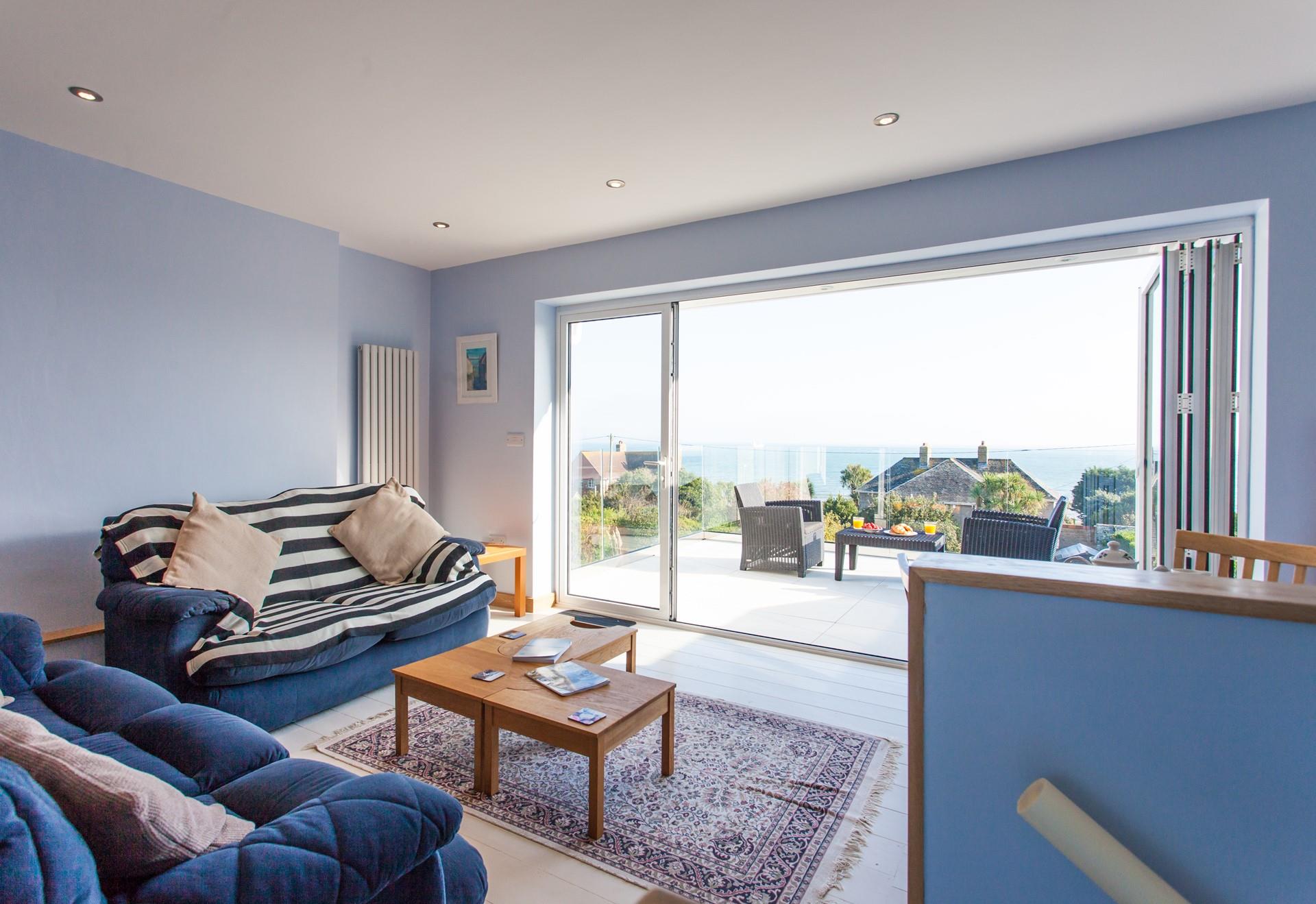 The spacious sitting room and balcony are perfect for enjoying the incredible sea views at any time of the day. 