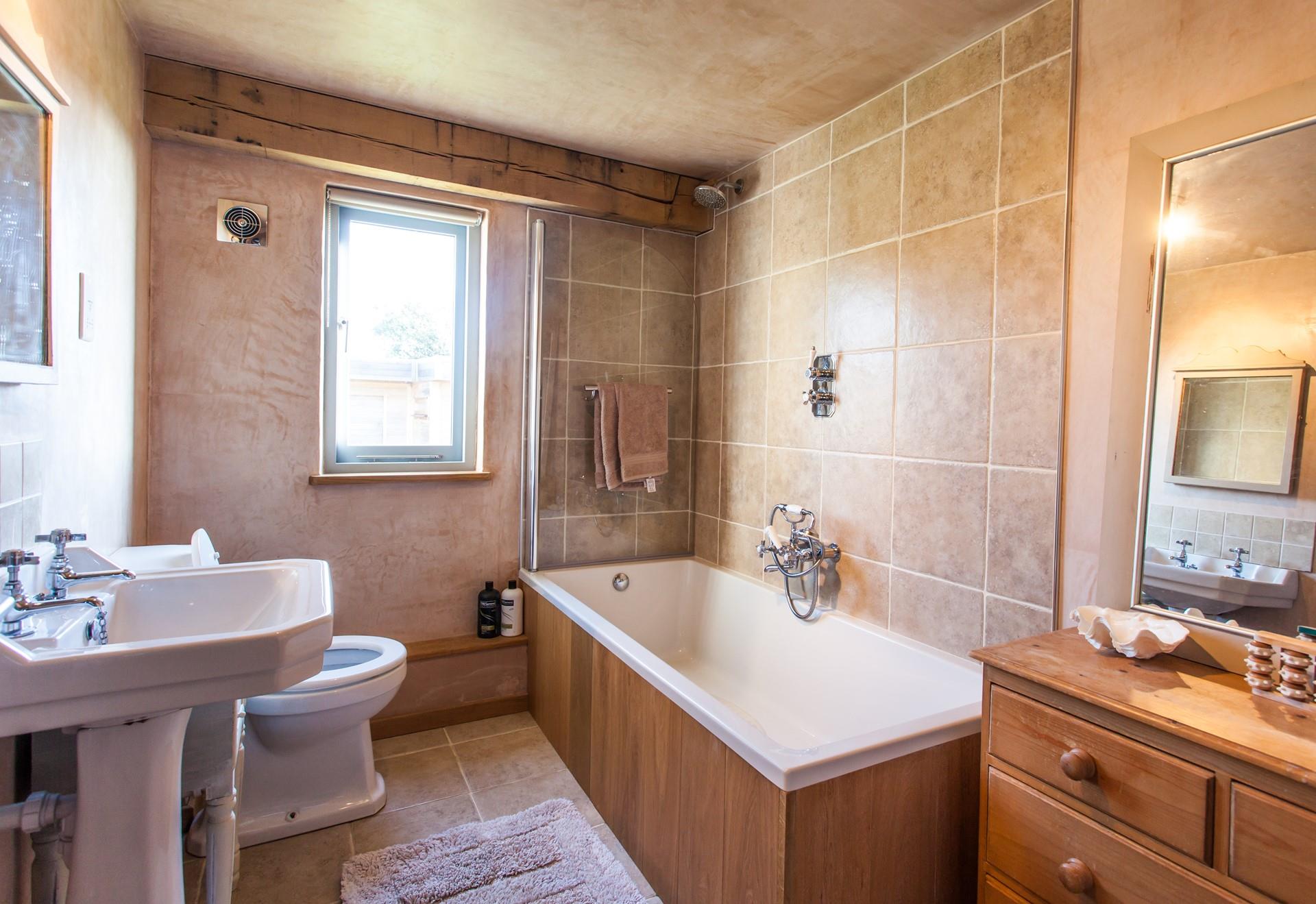 The bathroom's earthy tones and tasteful features have created a soothing, spa-like space; perfect for pampering yourself after a day exploring!