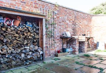 Guests will find an ample supply of firewood for the fire pit.