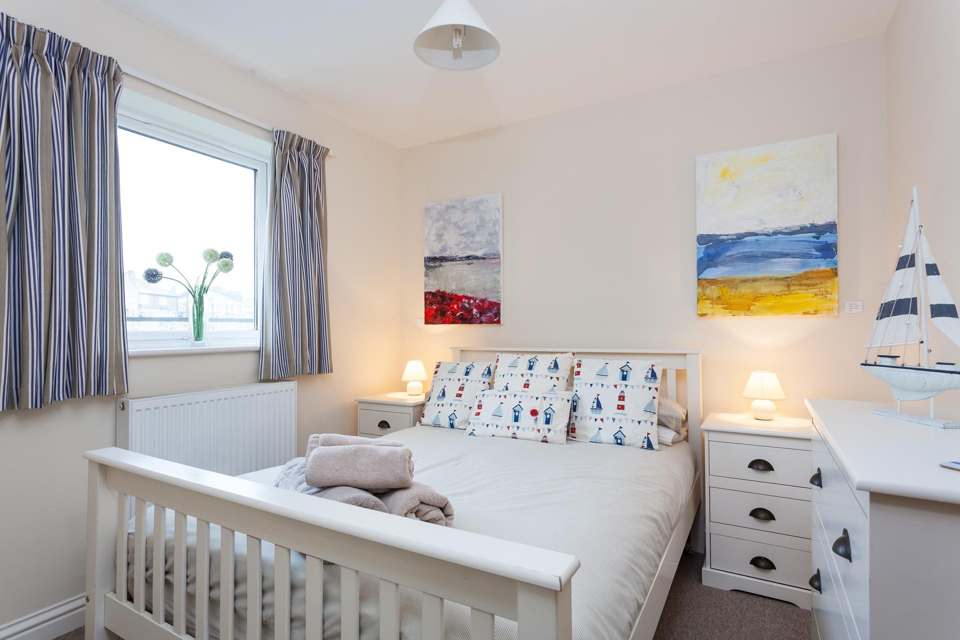 The gorgeous bedroom blends nautical design with modern comfort, promising a fantastic night's sleep.