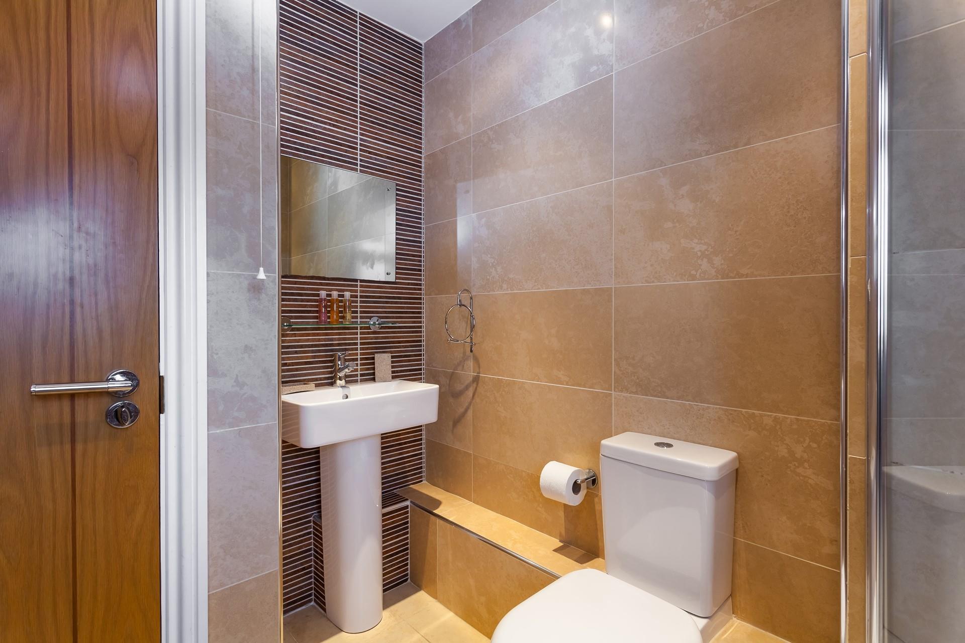 The stylish tiles and sleek design give the bathroom a spa-like feel, perfect for pampering yourself!