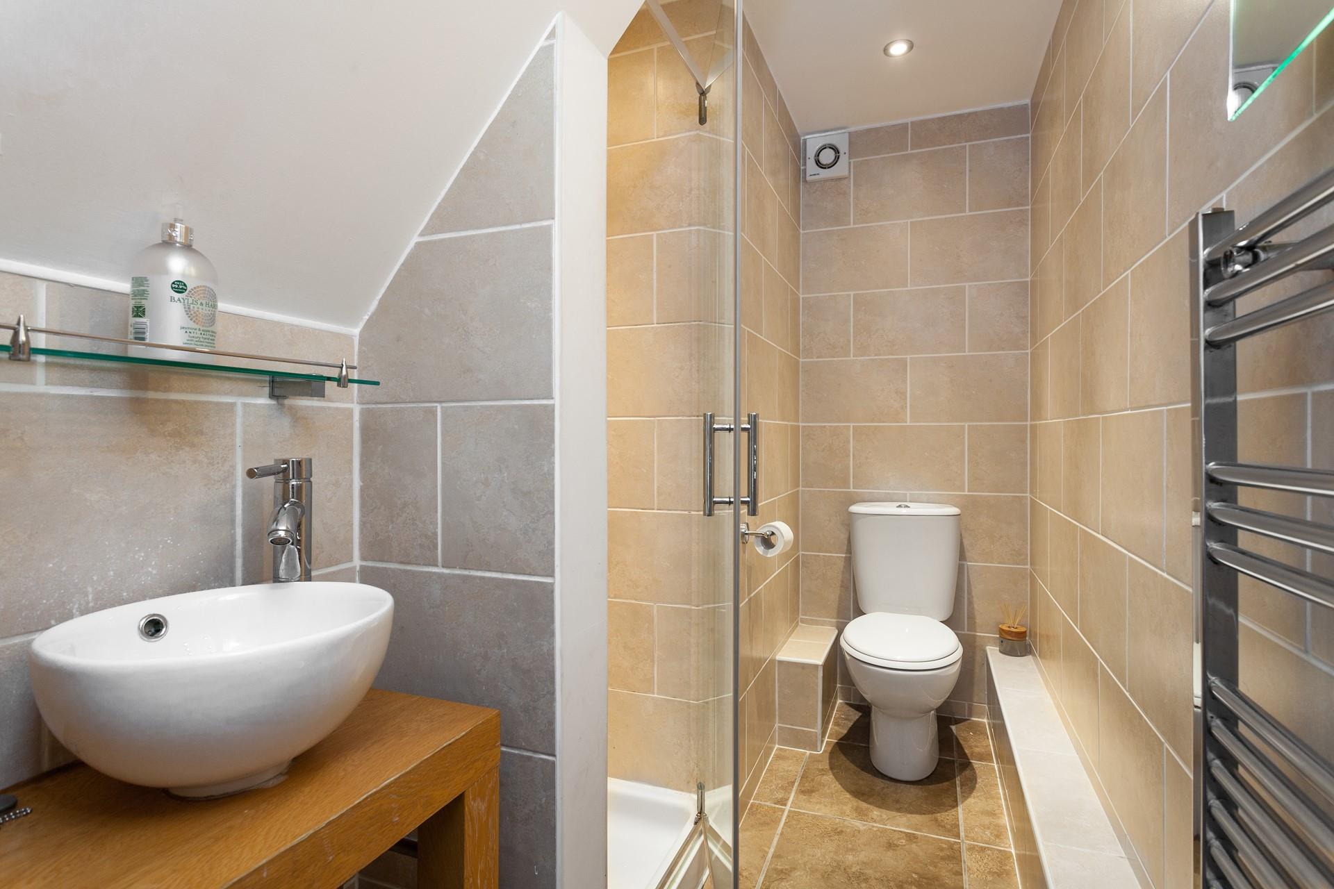 Sleek and stylish, the en suite is a lovely space to get ready for the day in.