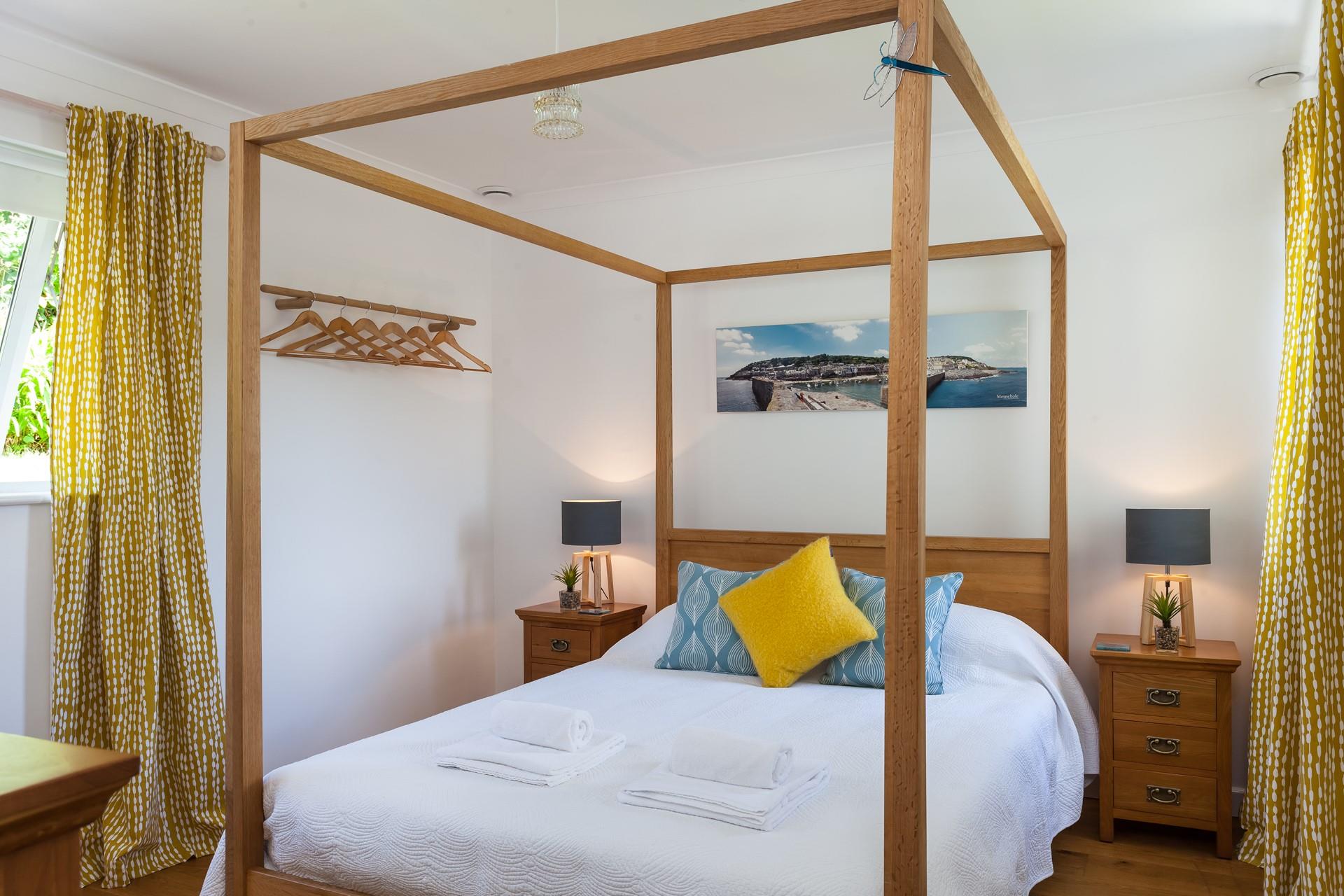 The grand four-poster king size bed offers you a sumptuous night's sleep.