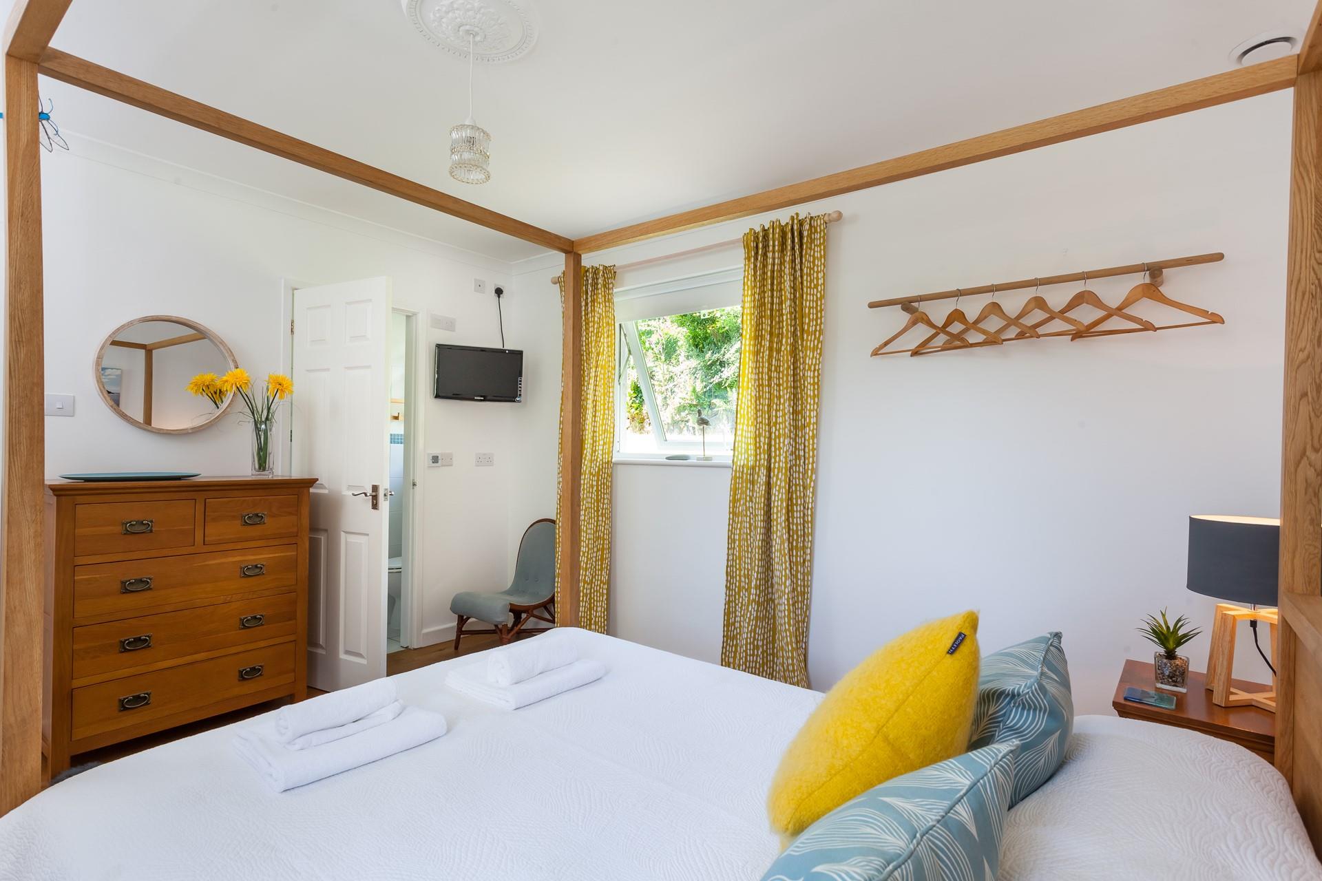 The spacious king size bed is perfect for enjoying a restful night's sleep after a busy day exploring the coastline.