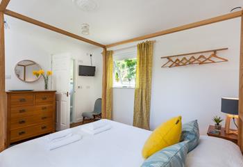 The spacious king size bed is perfect for enjoying a restful night's sleep after a busy day exploring the coastline.