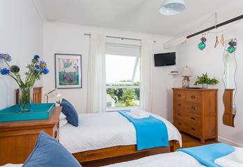 The twin room is decorated with whites and blues reflecting the proximity to the sea.