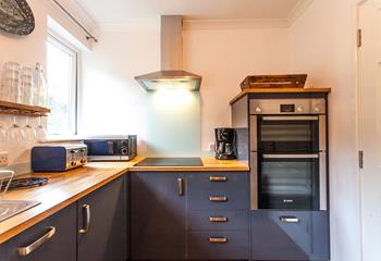 The modern well-equipped kitchen provides the chef of the family a space to cook tasty meals.