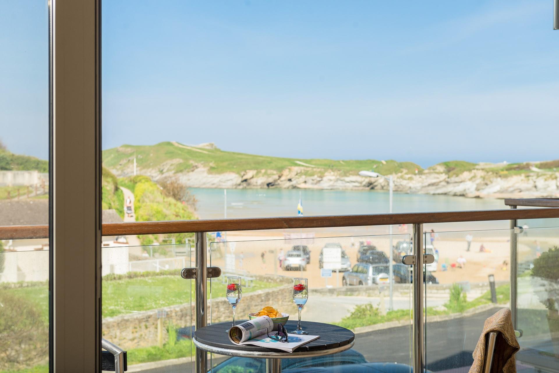 Doors open up from the living area to the balcony to enjoy stunning views of Porth beach.