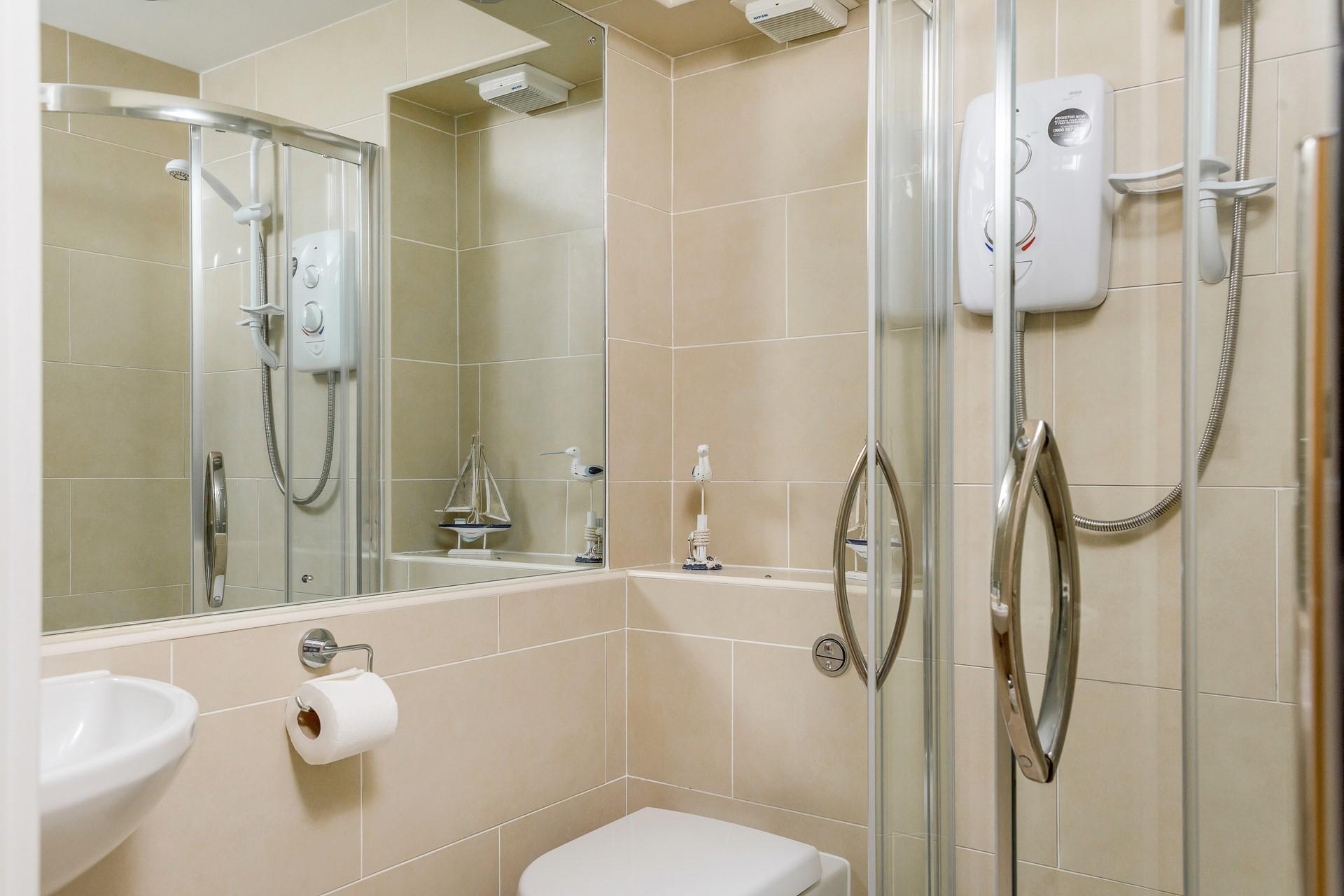 The en suite shower room benefits from an electric shower, perfect for invigorating yourself for the day ahead.