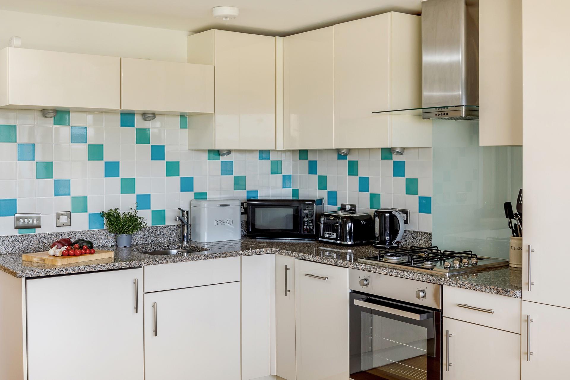 The kitchen is vibrantly decorated and well-equipped, perfect for cooking up a feast during your stay.