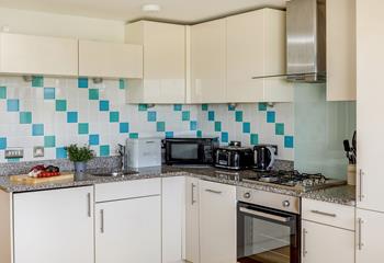 The kitchen is vibrantly decorated and well-equipped, perfect for cooking up a feast during your stay.