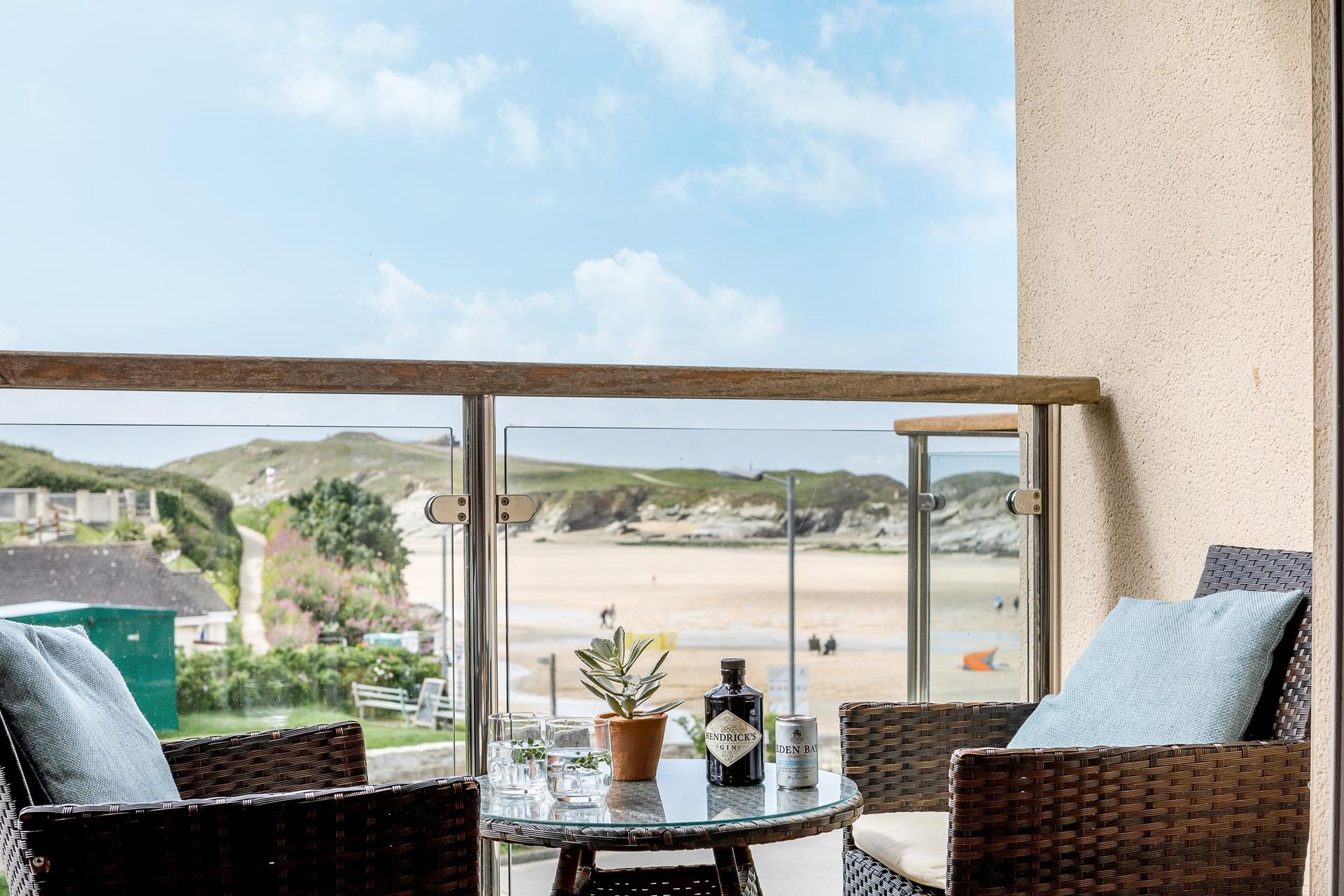Doors open up from the living area to the balcony to enjoy stunning views of Porth beach.