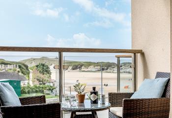 Doors open up from the living area to the balcony to enjoy stunning views of Porth beach.