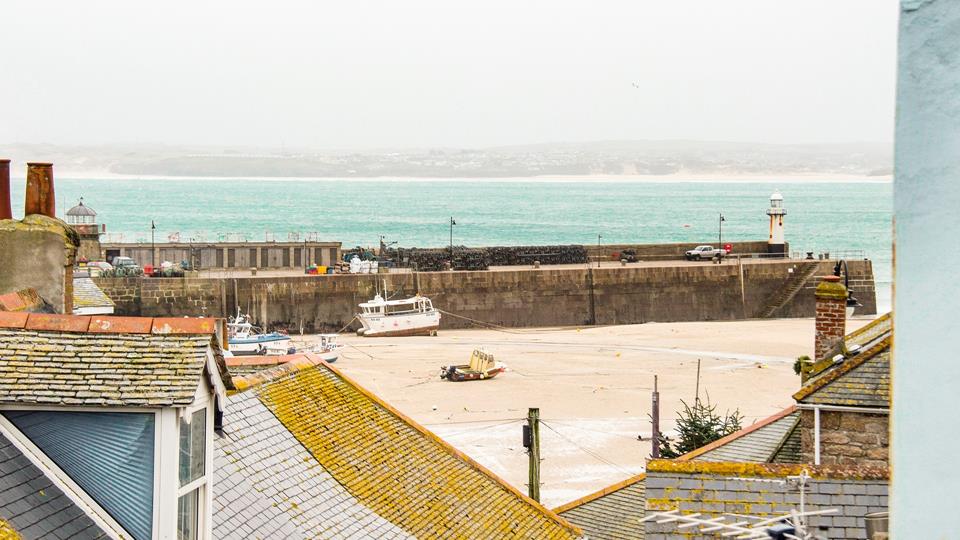 Gaze out over the iconic rooftops to the harbour and the sea in the distance. 