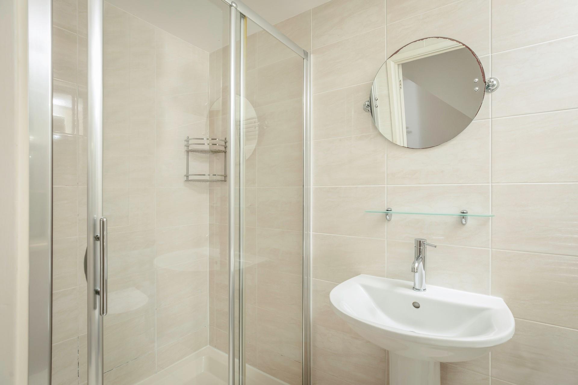The bathroom benefits from a spacious double shower.