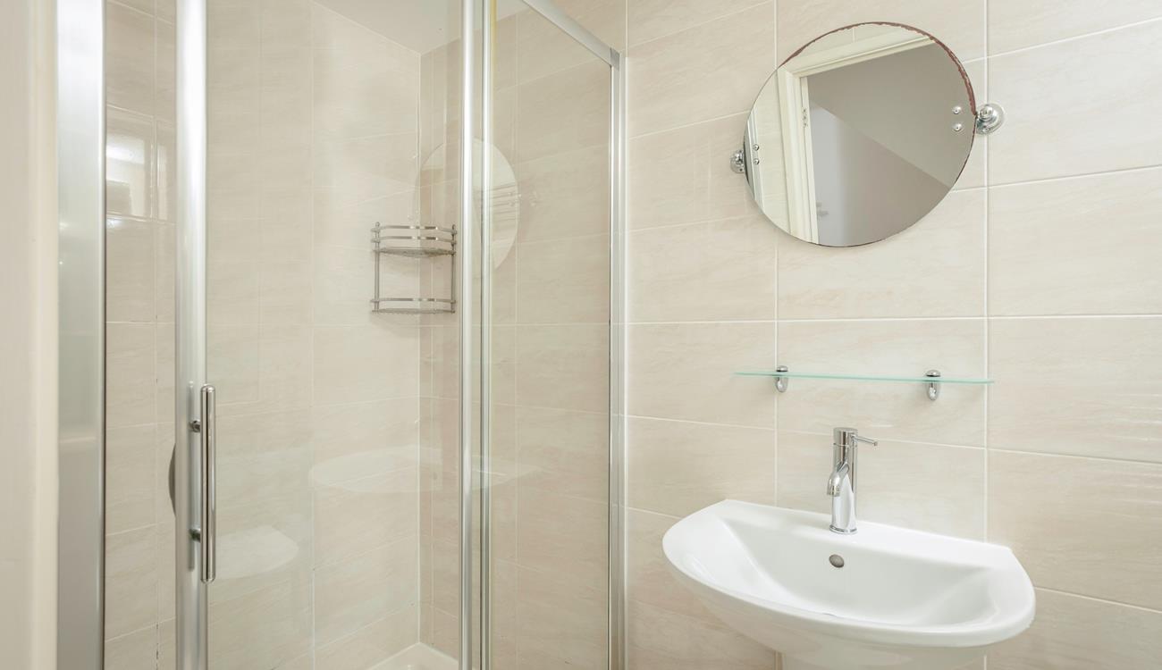 The bathroom benefits from a spacious double shower.