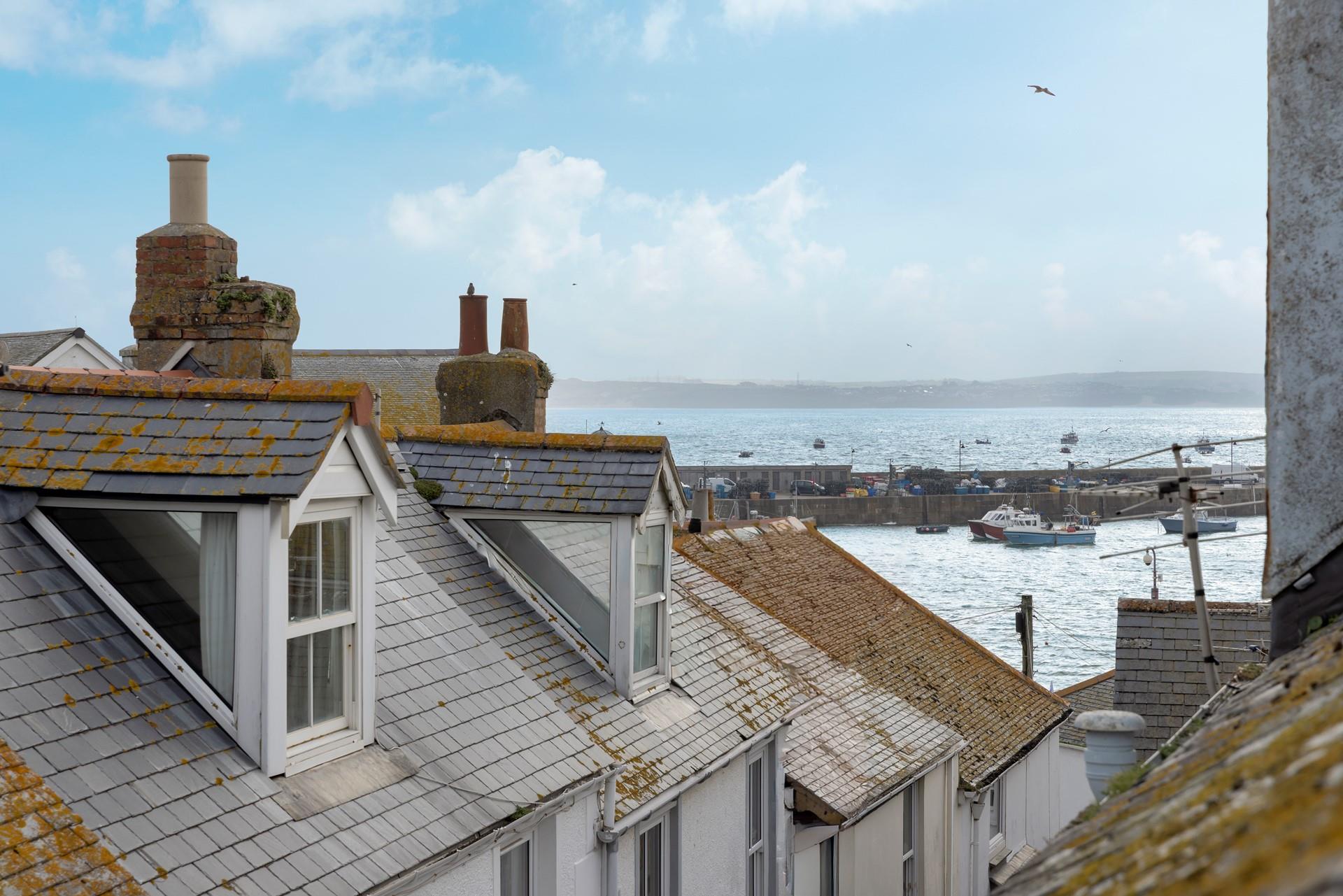 Gaze out over the iconic rooftops to the harbour and the sea in the distance. 
