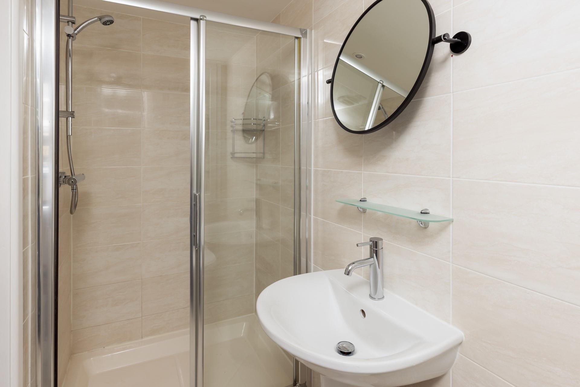 The bathroom benefits from a spacious double shower.