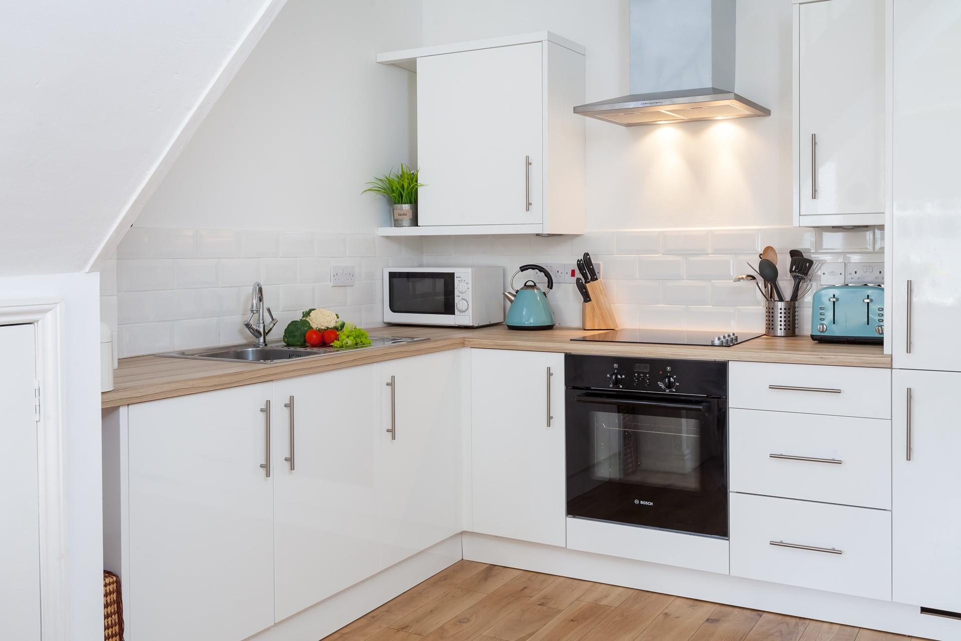 Modern and sleek, the kitchen is perfect for the chef of the family to cook up a storm.