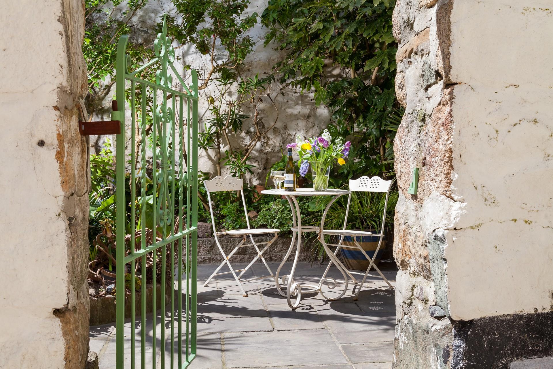 Enjoy the last of the day's sunshine out in the courtyard after a day out.