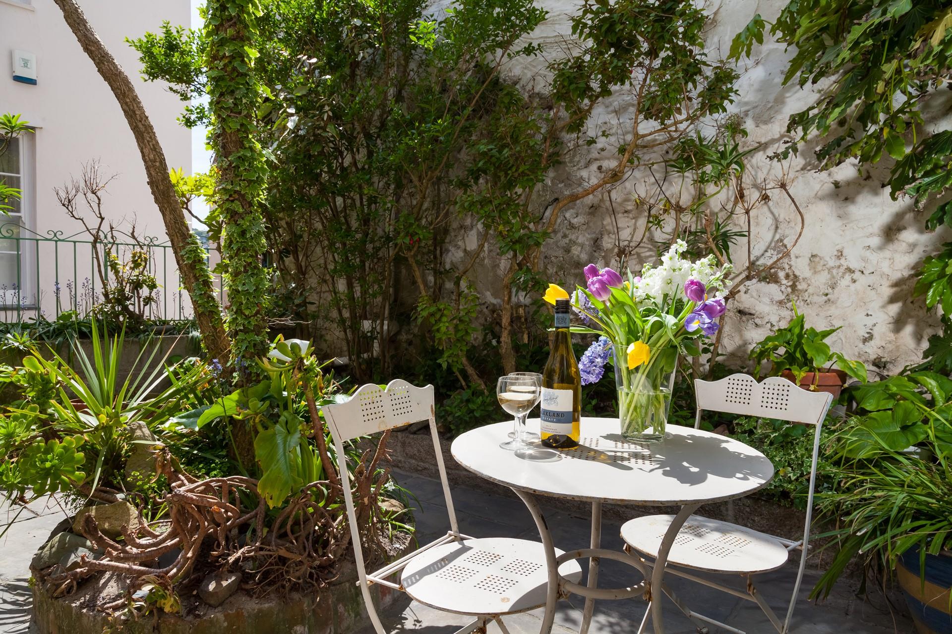 The courtyard is beautifully maintained with borders bursting with life.