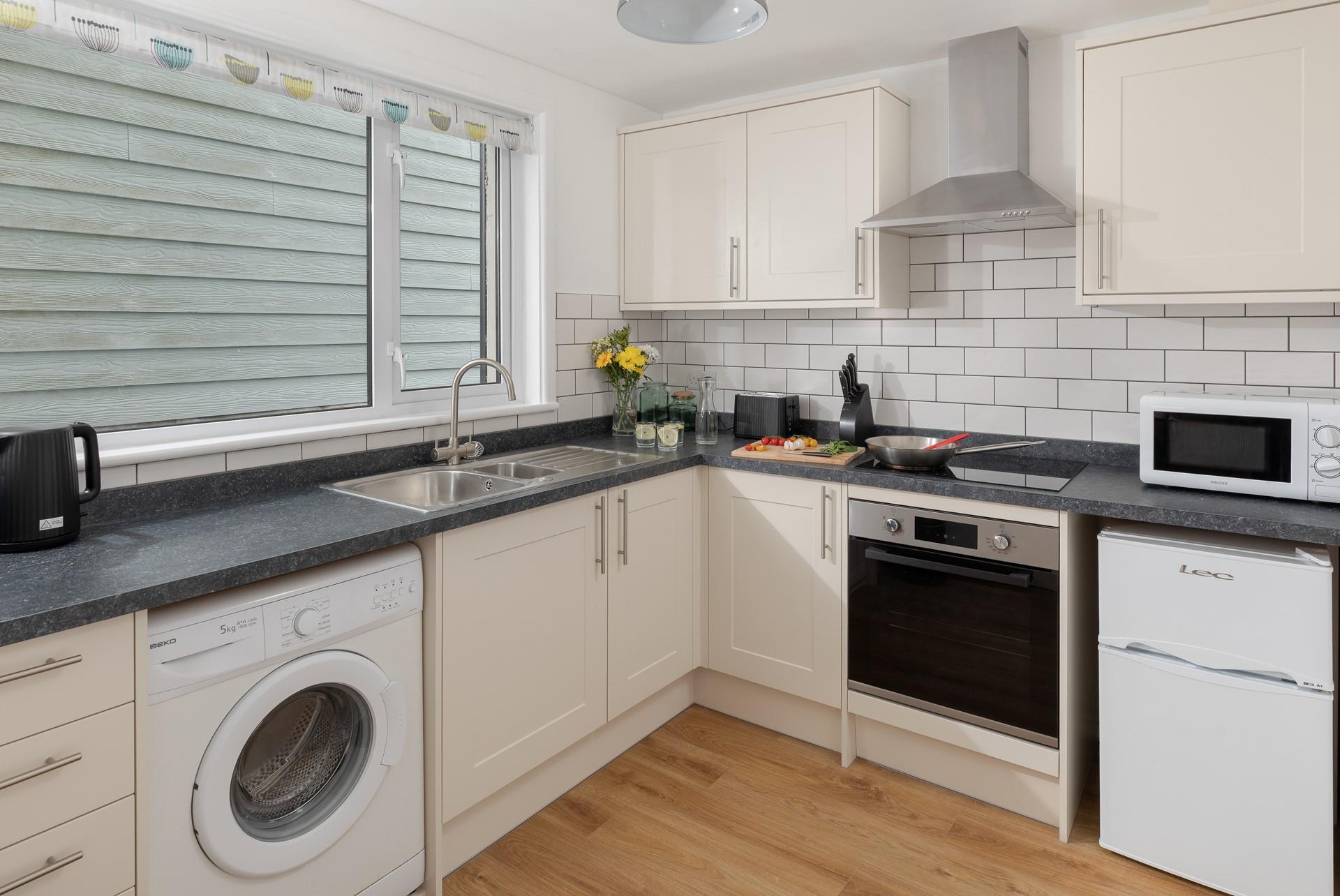 The kitchen is a functional space with plenty of worktops available for you to rustle up some fine meals.