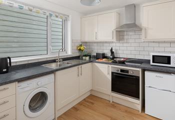 The kitchen is a functional space with plenty of worktops available for you to rustle up some fine meals.