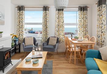 The living area has contemporary furniture and a tasteful use of colour.