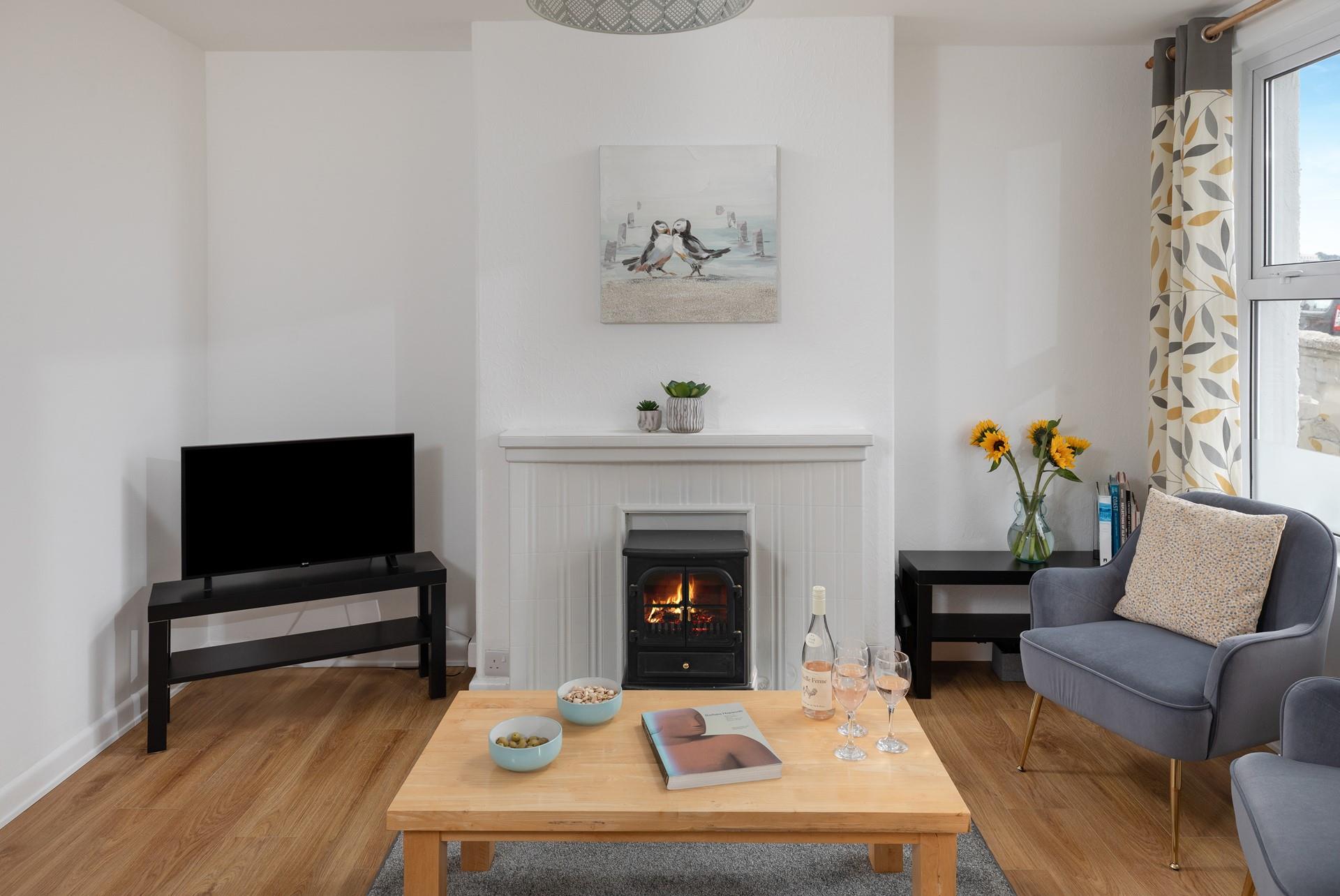 The living area has contemporary furniture and a tasteful use of colour.